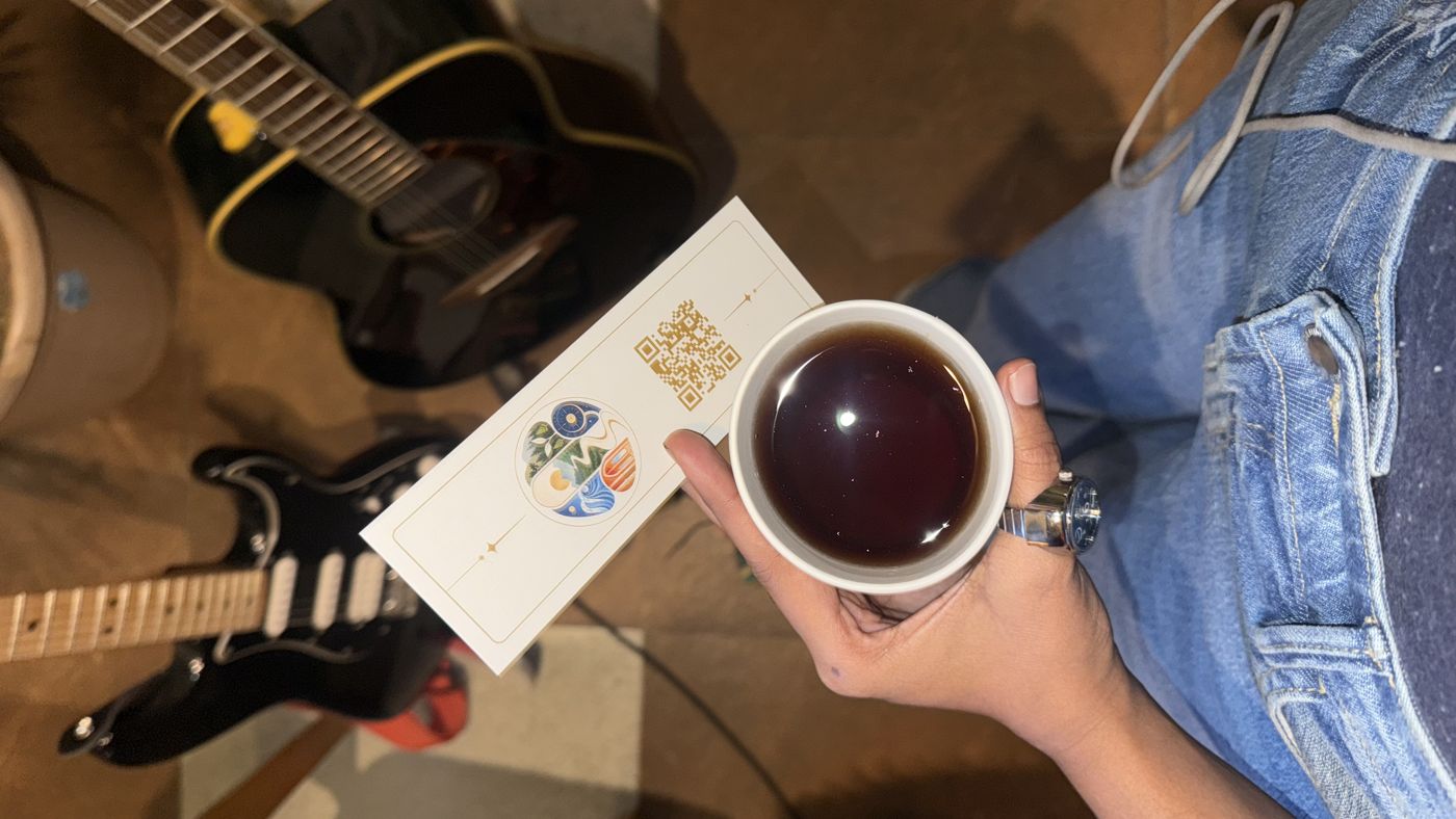Tea and a bookmark resting on a guitar